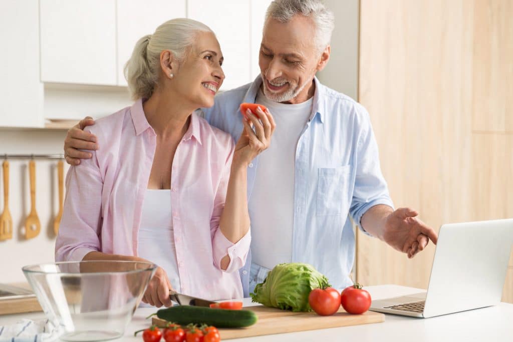elderly couple cooking healthy foods